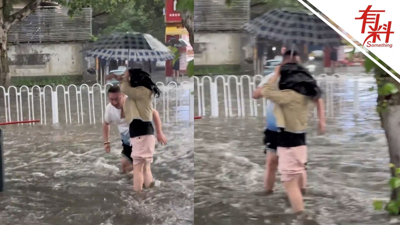 长沙突降暴雨路面积水 两位路人主动拦路劝退车辆和行人