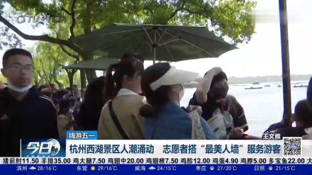 杭州西湖景区人潮涌动,志愿者搭“最美人墙”服务游客