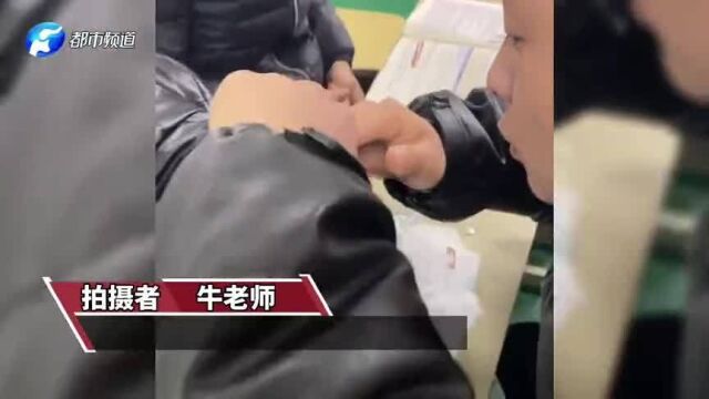 男生课间趴桌上睡觉,同学把同桌坐垫拆了给男生盖上