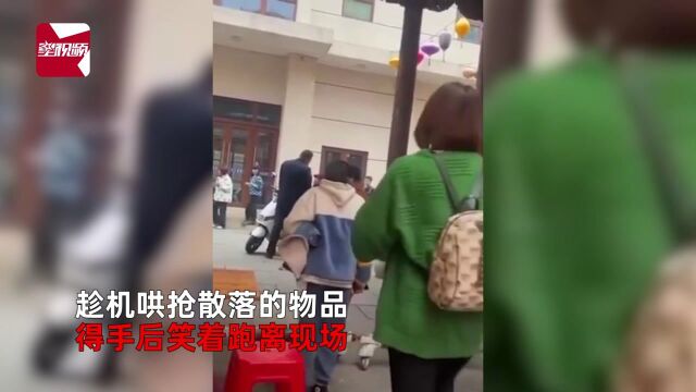 城管没收小贩商品,2女子笑着牵娃哄抢玩具,女孩用力挣脱喊不要