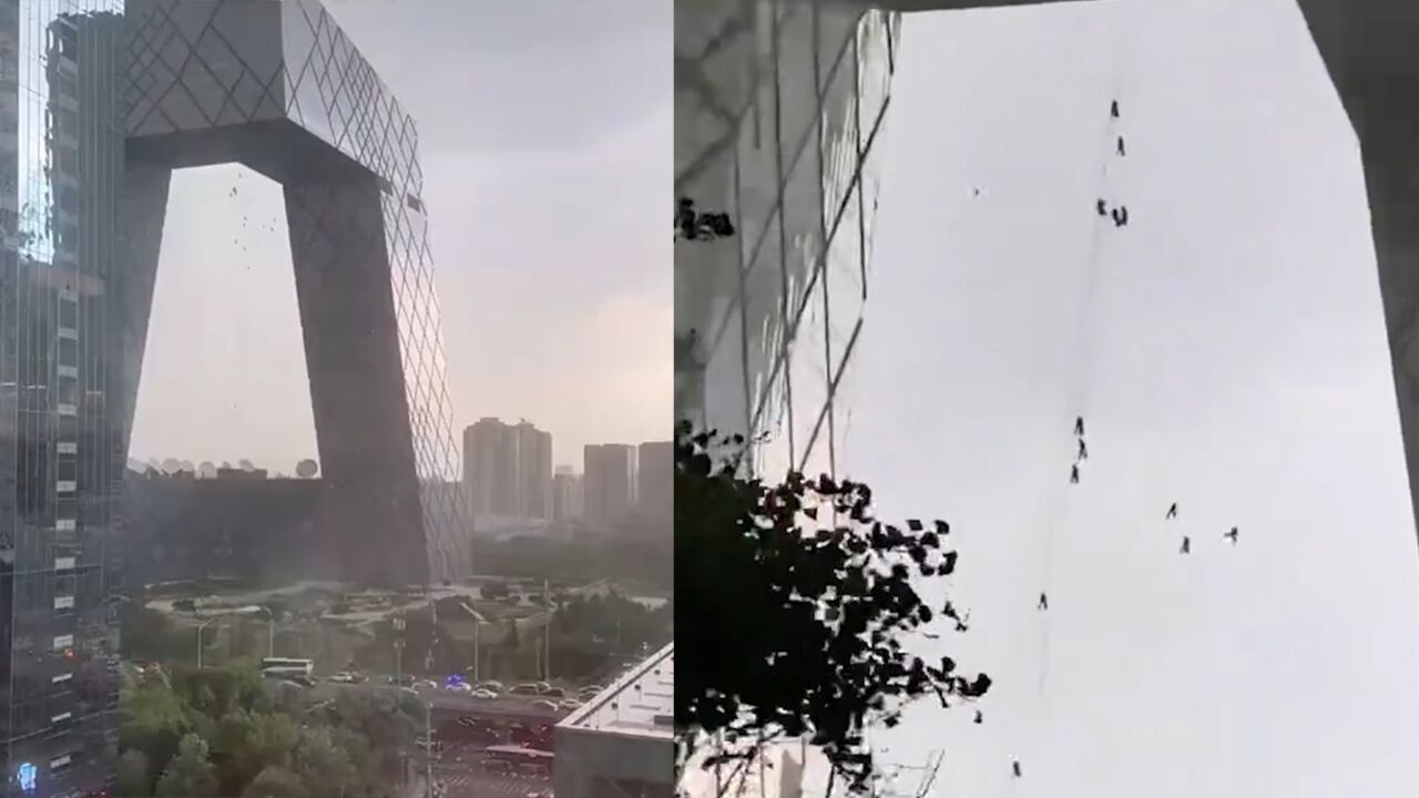 暴雨突袭北京,外墙工人悬挂高空慌忙收绳,风雨中飘摇令人心惊