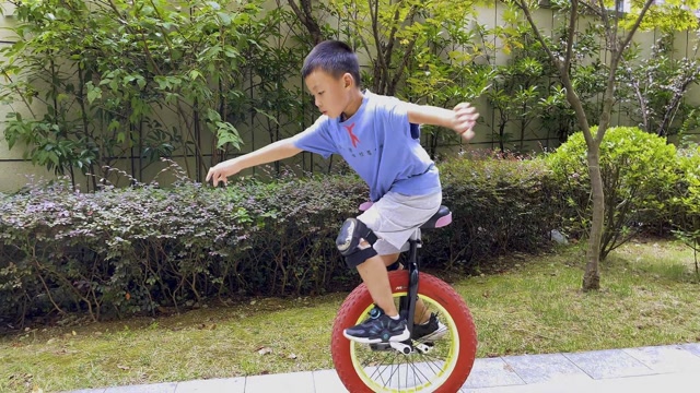小男孩骑独轮车上车骑行