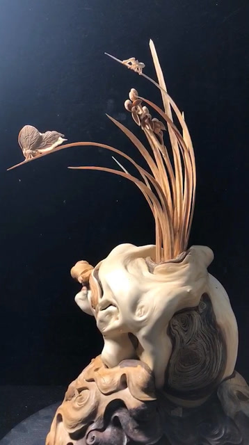 木头雕刻的素心兰花.有蜗牛蝴蝶和蚂蚁哦