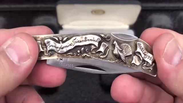 一把收藏版小型折刀,刀身雕刻精致图案,看起来高端大气