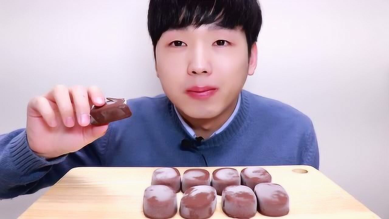 小哥穿着毛衣吃巧克力脆皮冰淇淋,这样就不会冻得瑟瑟发抖了吧