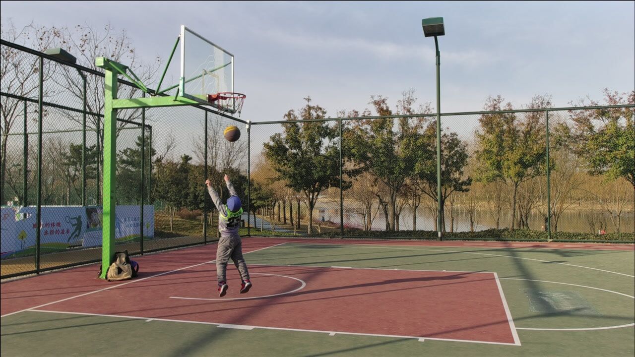 小男孩公园训练篮球父母是孩子最好的老师传道受业解惑