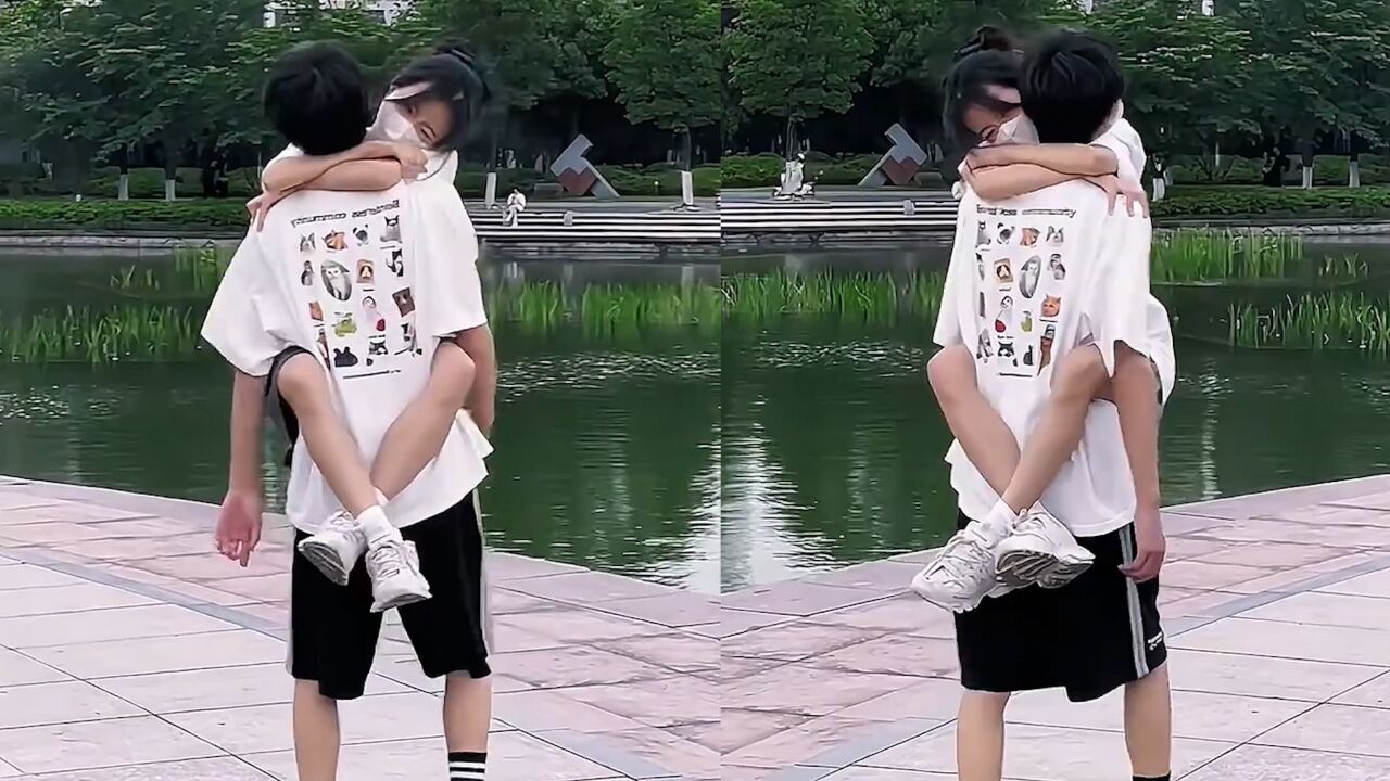 女生像树袋熊般抱男友身上,男友抖动身体甩也甩不掉,女生笑开花