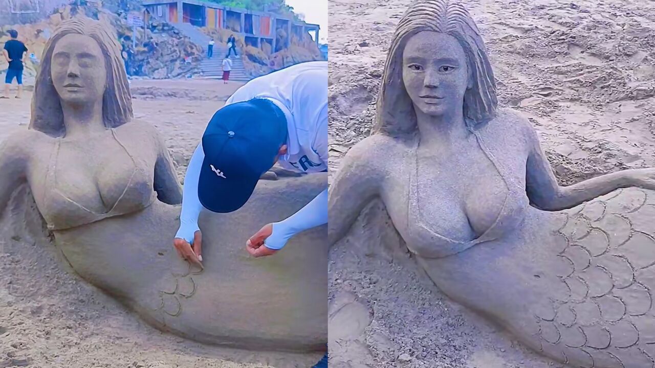 男子用沙子堆出美人鱼,勾画眉眼鳞片栩栩如生,仿佛下秒就要入海