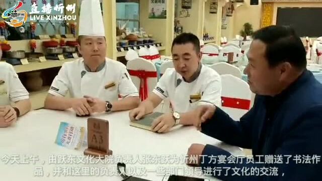 跃东文化大院负责人张东跃走进忻州丁方主题酒店为获得忻州市十大名厨员工赠送书法作品!