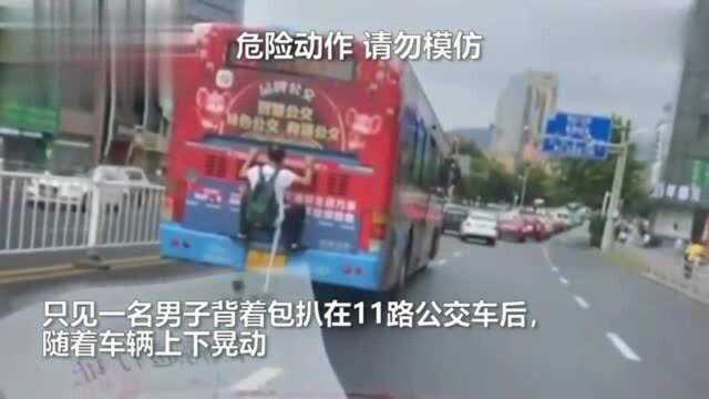 网传一男子扒公交车尾“乘车” 公交公司:正在进行后续调查