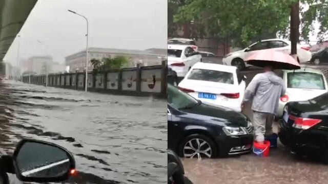 长春暴雨致路面积水严重 男子自制\