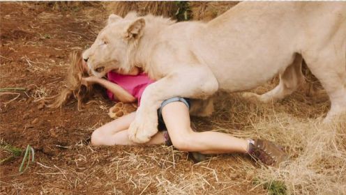 淘气女孩不听动物学家的告诫，故意背对着狮子，结果让人痛心疾首