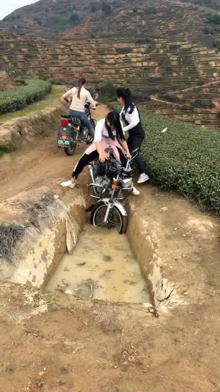 美女骑摩托车陷进泥坑图片