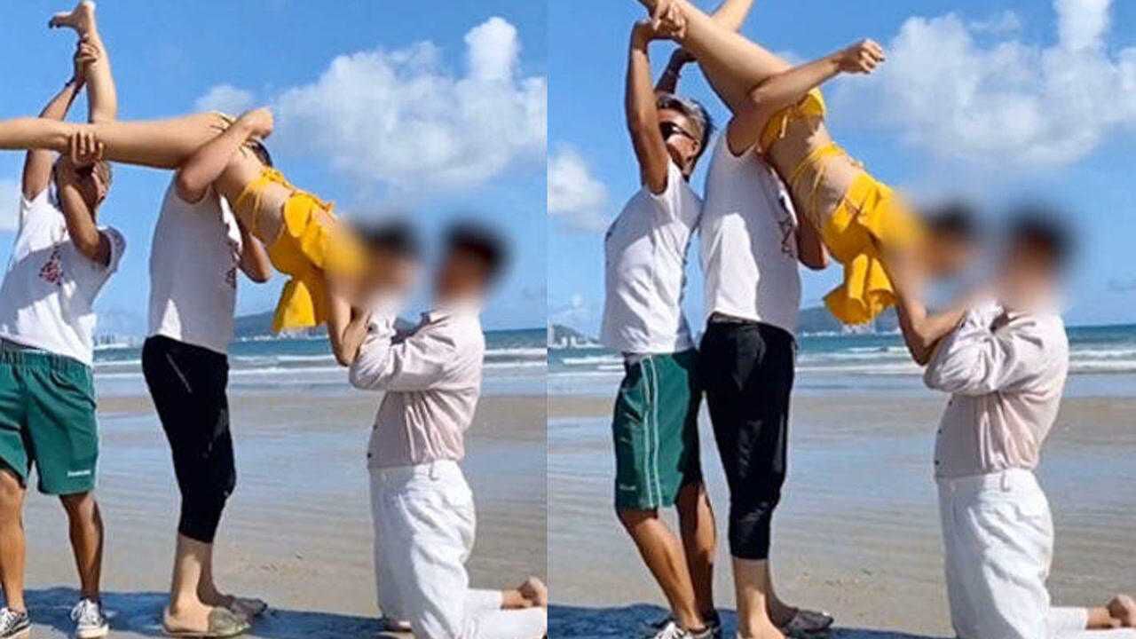 情侣海边拍摄高难度写真照,两男子托举女生双腿,看成片网友炸锅